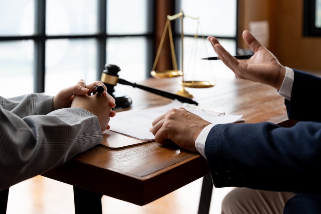 business people and lawyers discussing contract papers sitting at the table. Concepts of law, advice, legal services.